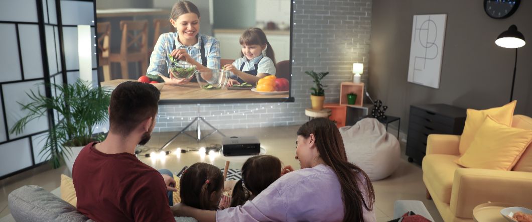 The Difference Between High Definition, Standard Definition, and Low Definition Video Family watching home videos on a projection screen