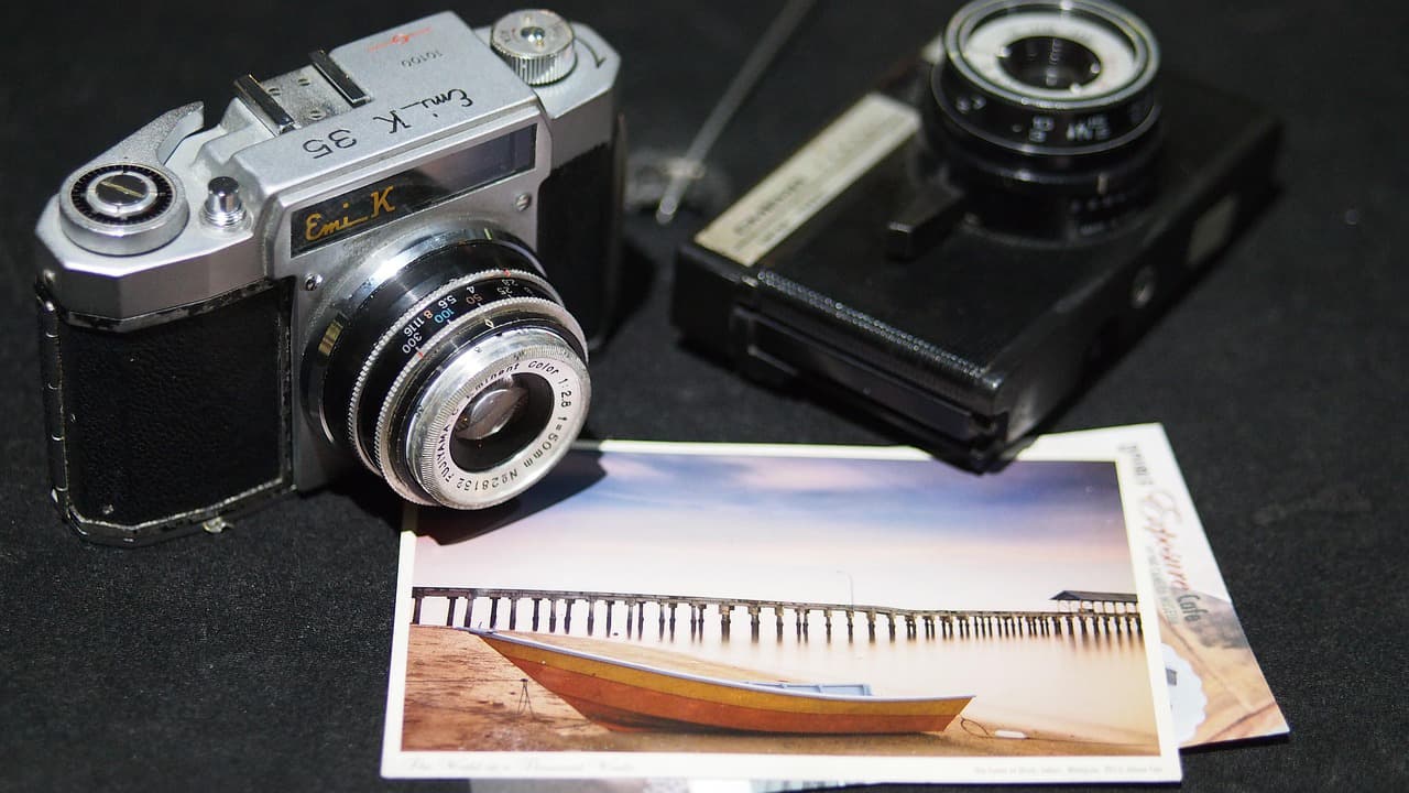 A 35mm camera and photo prints
