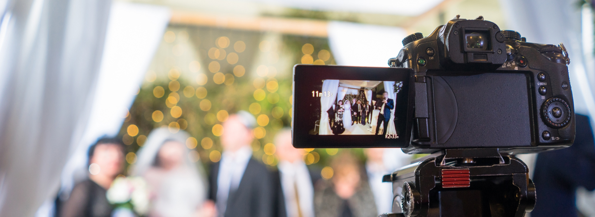 Professional video camera recording a wedding ceremony, representing custom video editing services by DVD Your Memories in Southern California.