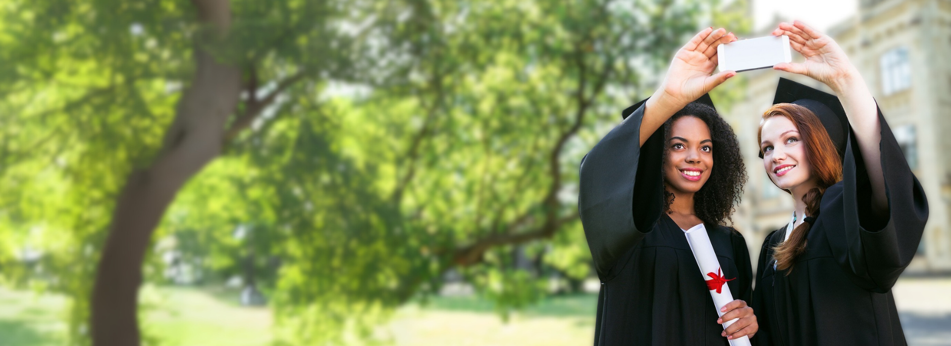 Graduates taking selfie in caps and gowns, representing custom video editing services by DVD Your Memories Los Angeles.