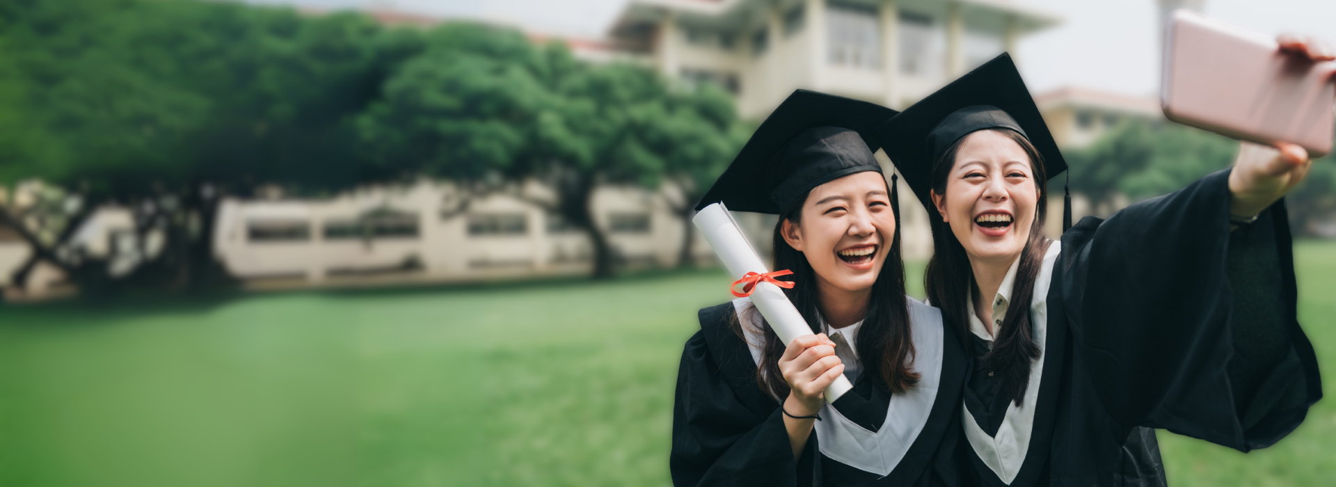 Graduates taking selfie in caps and gowns representing custom video editing services by DVD Your Memories Orange County.