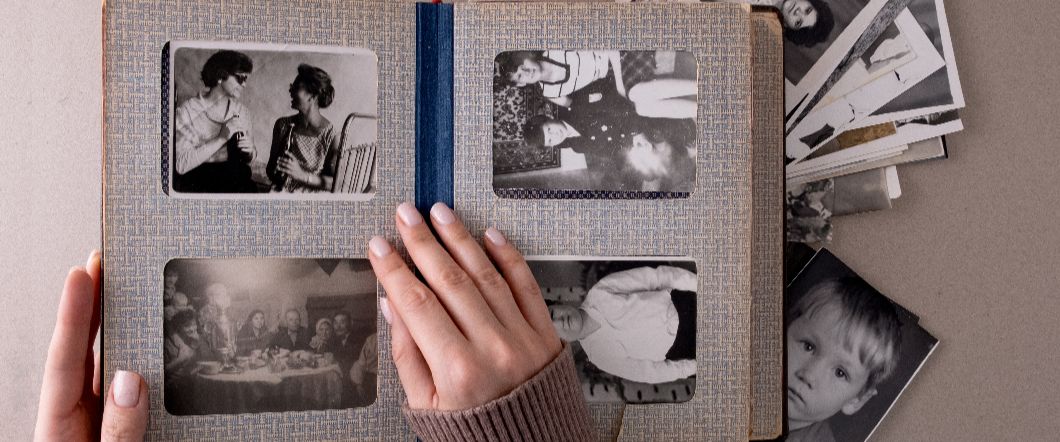 Someone looking through their scrapbook and collection of old photos