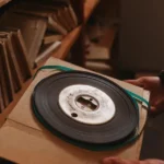 An 8mm film reel on a backing, able to be measured.