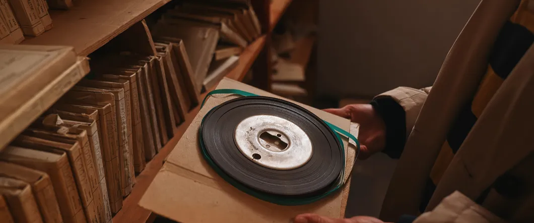 How To Estimate The Runtime Of An 8mm Film Reel An 8mm film reel on a backing, able to be measured.