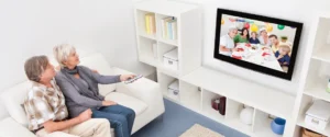 People on a couch watching a digitized home movie