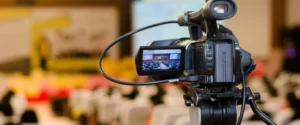 Someone filming on an old film camcorder, with dates visible.