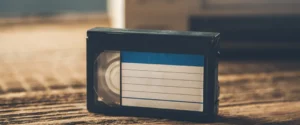 Umatic tape with blue label rests on carpet.